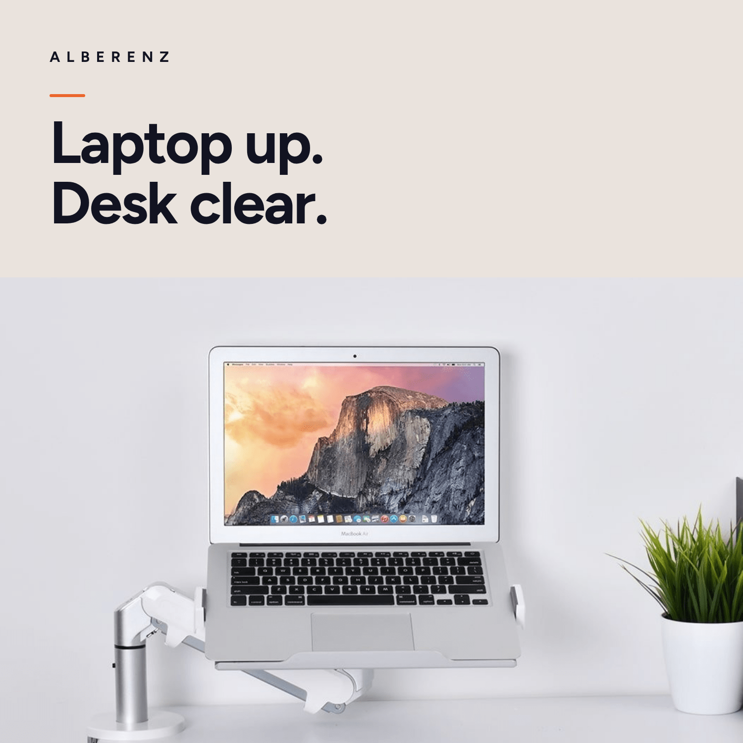 Alberenz gas spring laptop arm, silver: laptop raised above a bright desk, the desktop stays clear