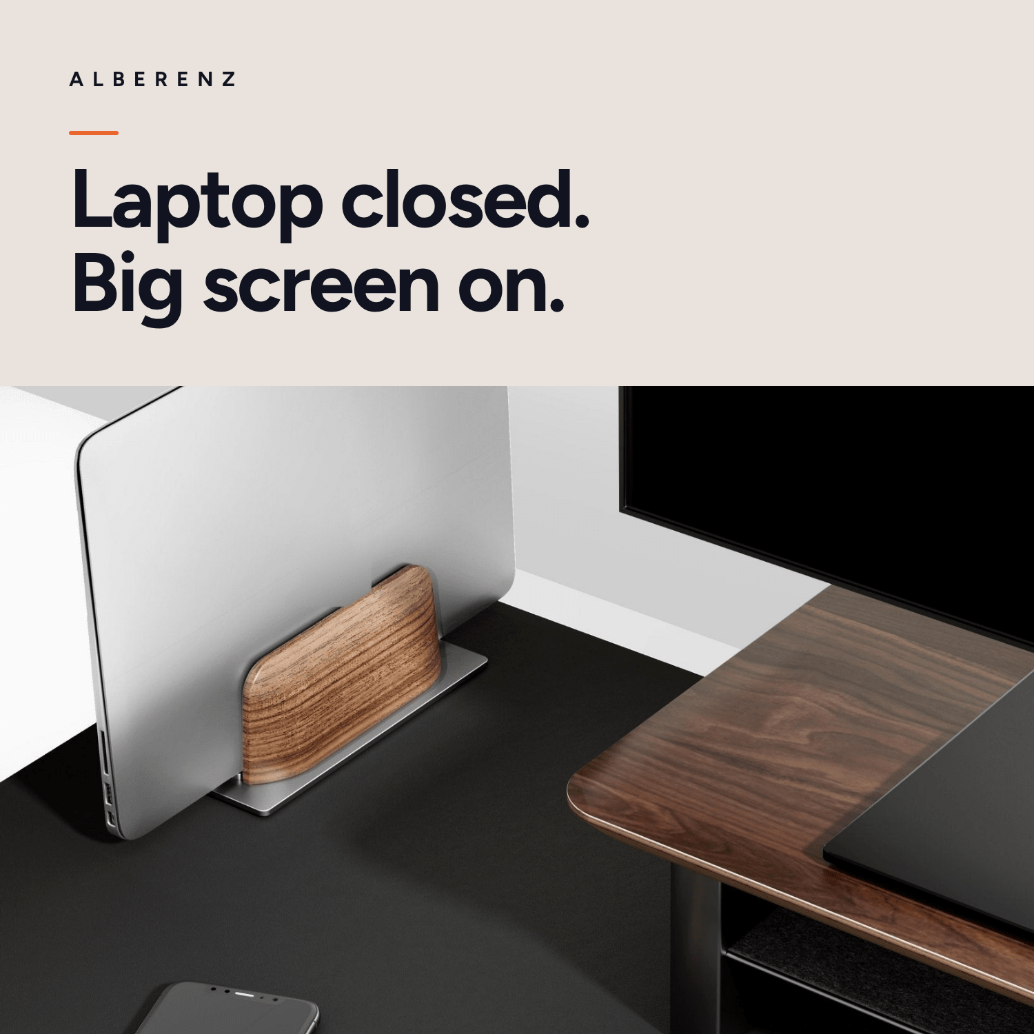 Alberenz vertical laptop stand in walnut: closed laptop next to a large screen